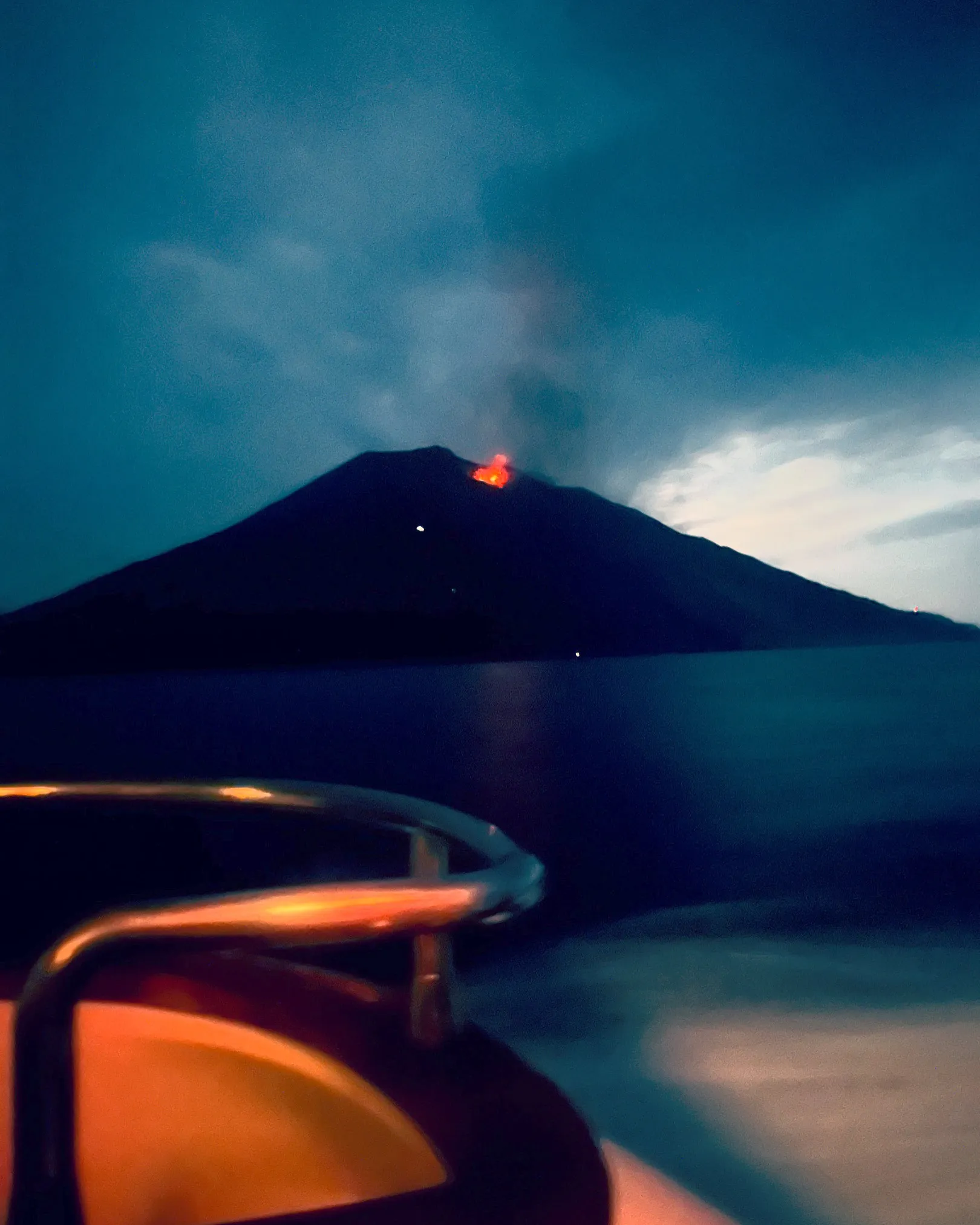 Stromboli erupting at night, seen from the boat