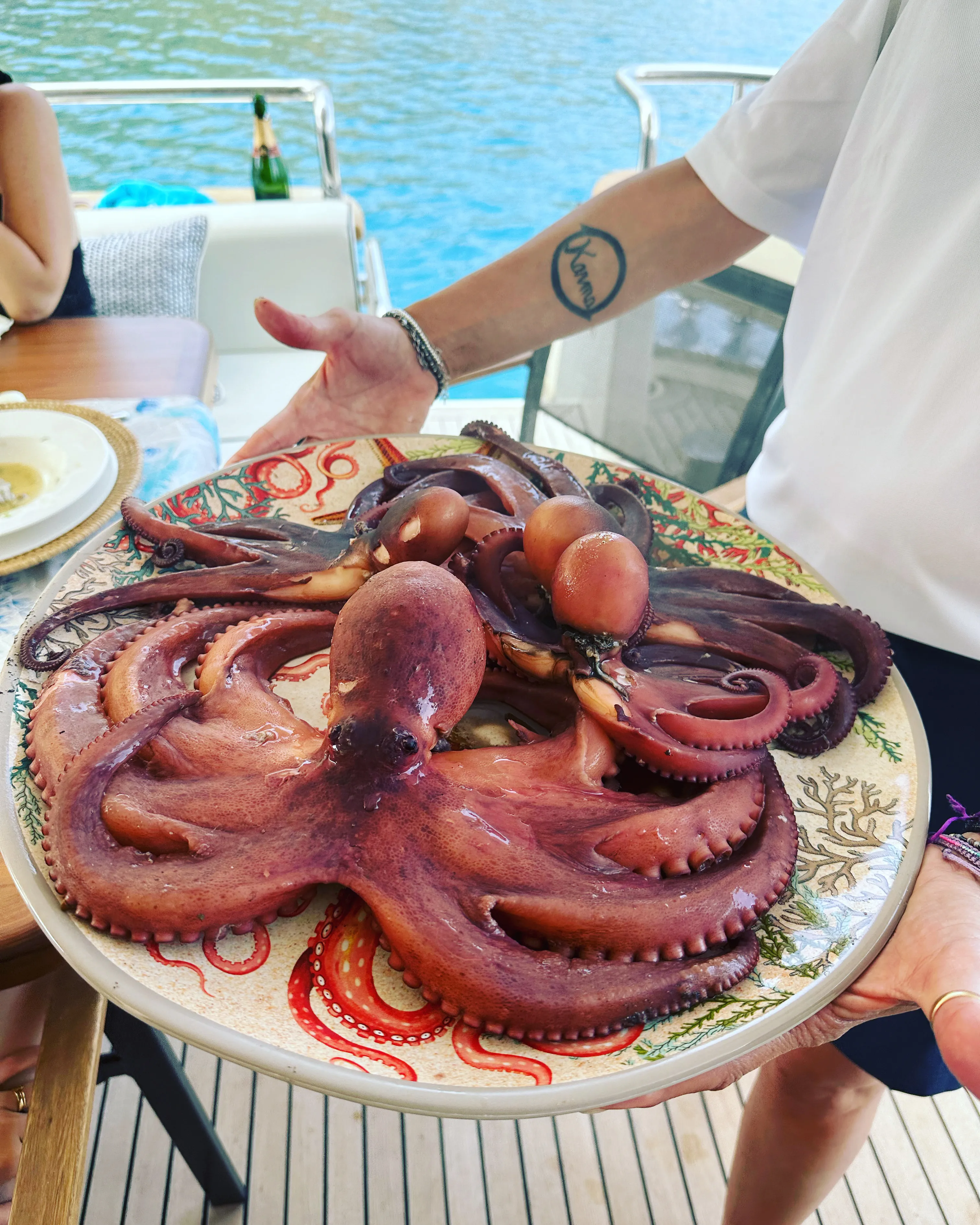 The octopus brought to the table on a coral-painted platter